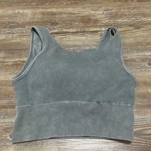 I’m selling this blueish-grey top that is cropped and padded and has an athletic